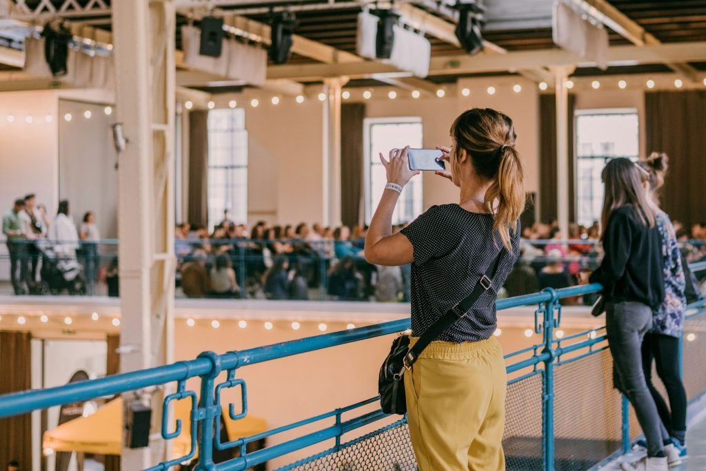 Event venue. Woman taking a picture of an event venue with her mobile phone New Bern, NC.