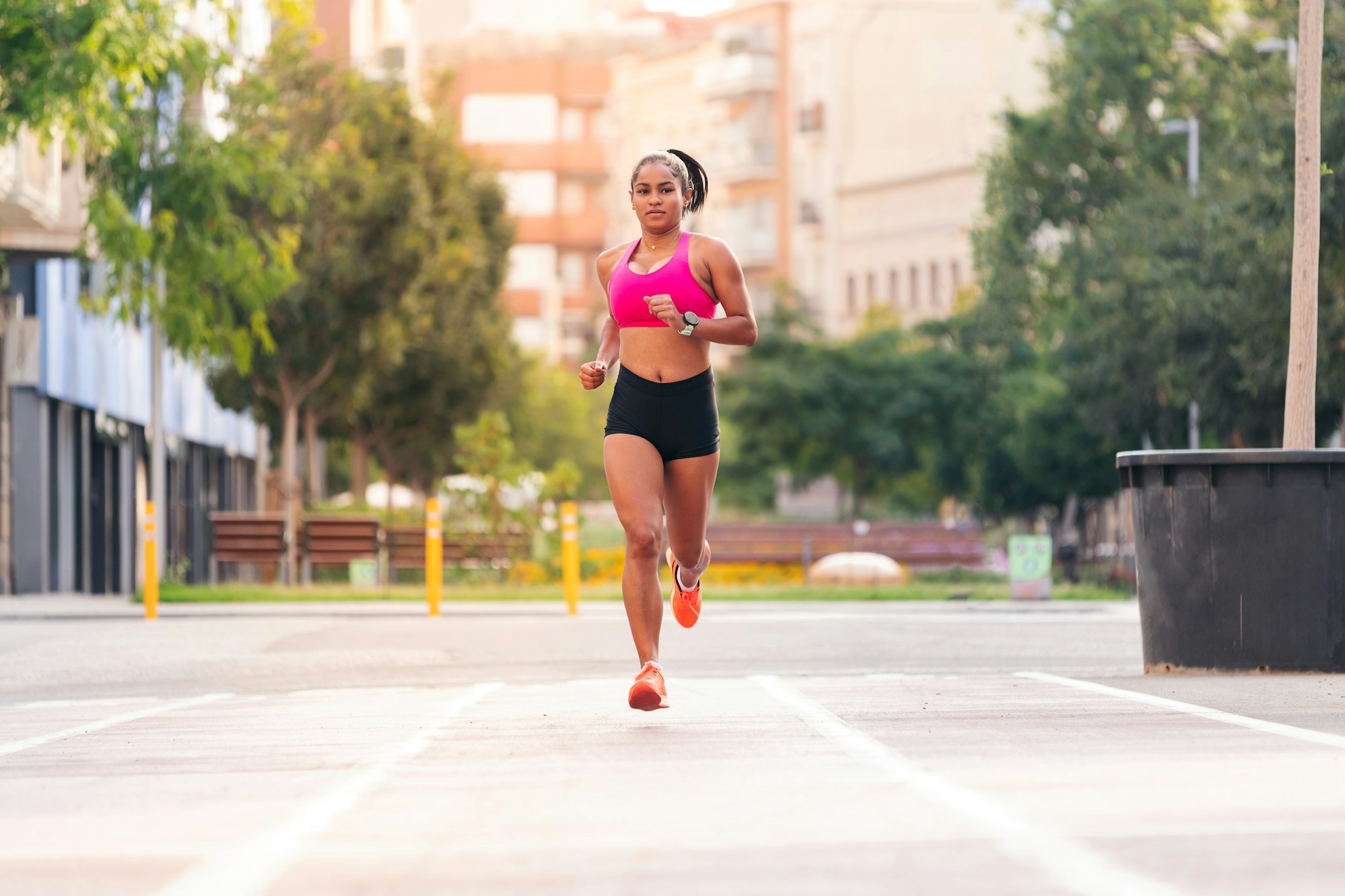 latin sportswoman running on the city