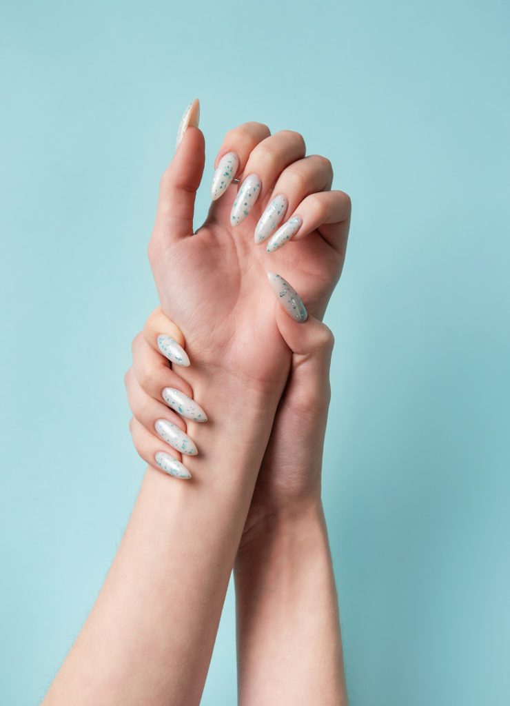 Female hands with blue nail design. Blue nail polish manicure.