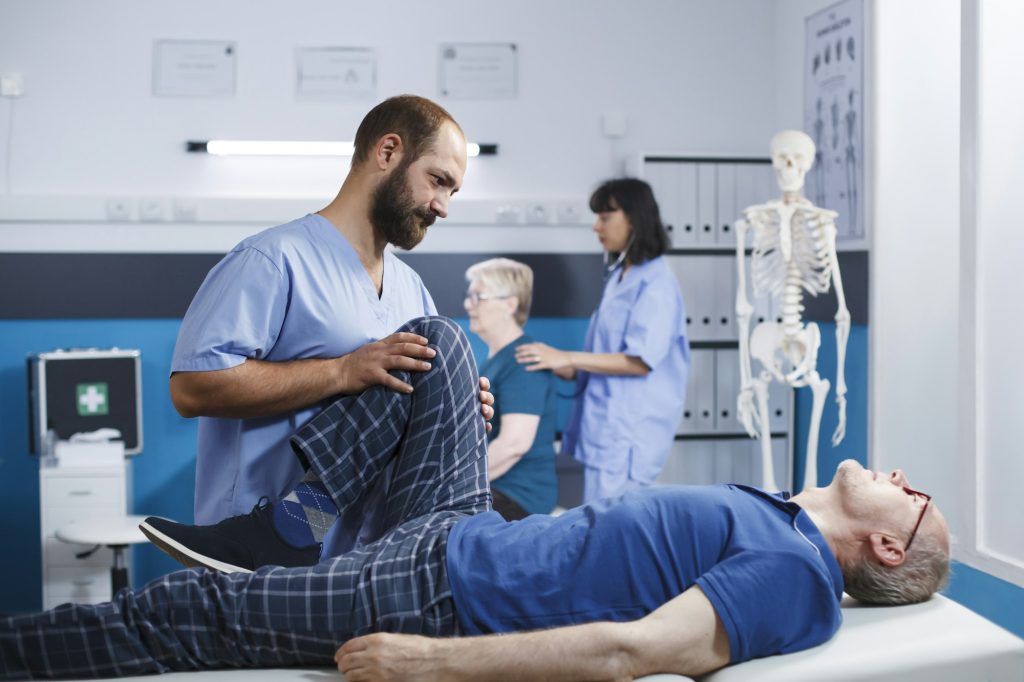 Senior man receiving orthopedic massage